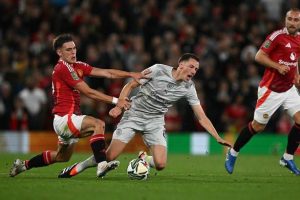 Manuel Ugarte of Manchester United tackling